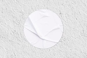 Round Sticker Mockup on Wall Texture Background