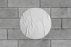 Round Wrinkled Poster on Brick Wall Mockup