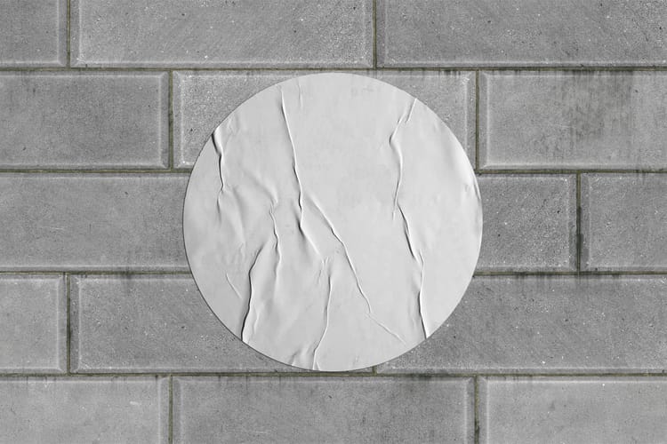 Round Wrinkled Poster on Brick Wall Mockup
